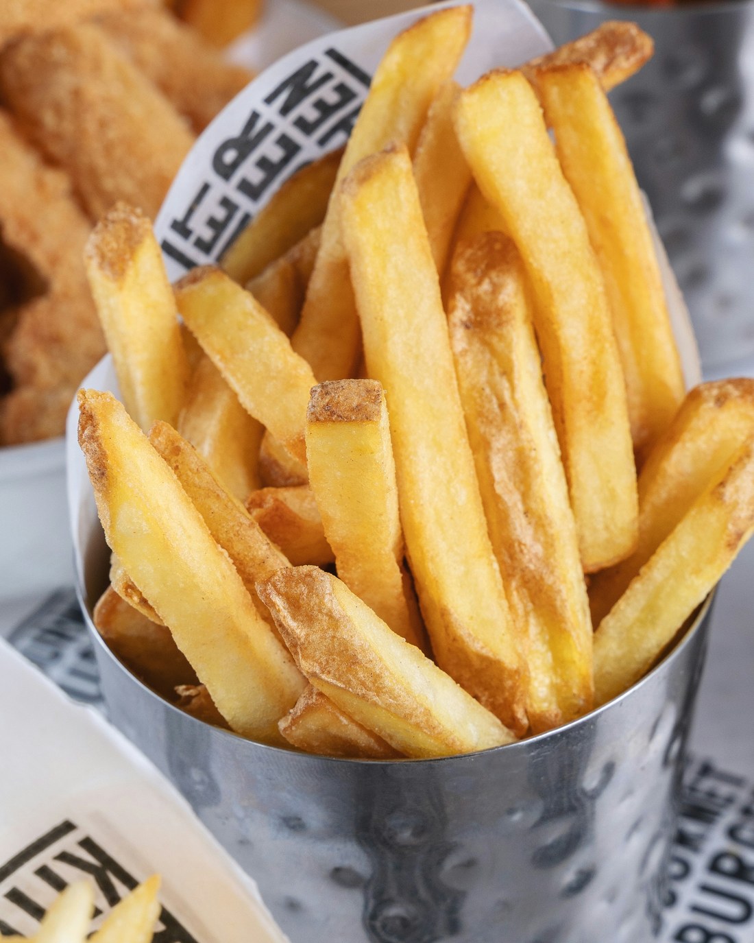 Golden slap chips in a metal cup