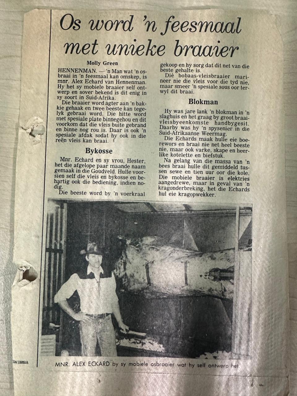 1986 newspaper clipping: Alex Eckard beside the mobile ox-braai he built himself