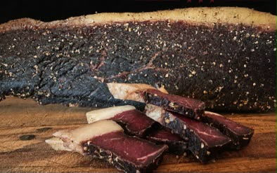 Slab of spiced biltong with slices cut from it